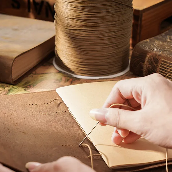 Hand-stitching the leather journal