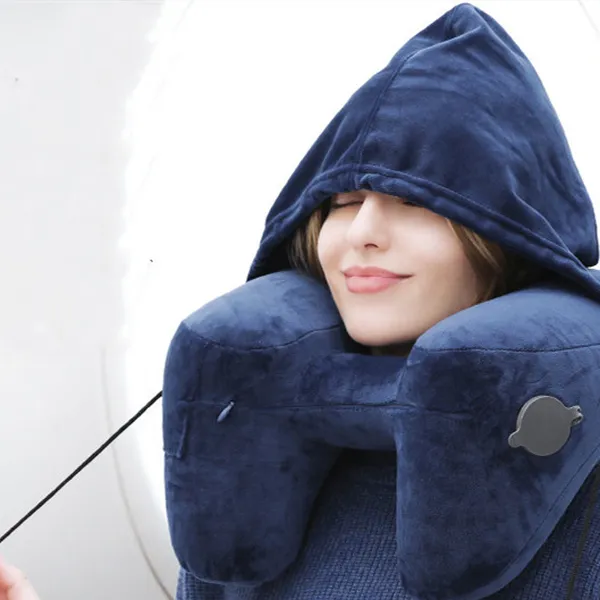 Inflated pillow and hood worn by a plane window