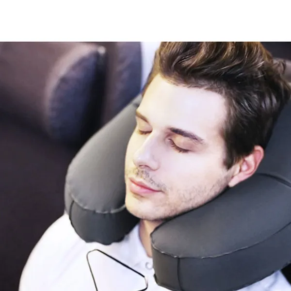 Inflatable pillow worn in an aircraft seat