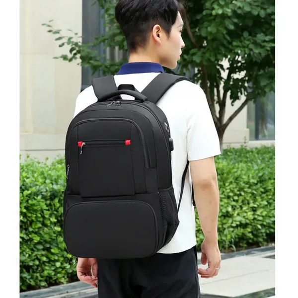 Black backpack worn outdoors